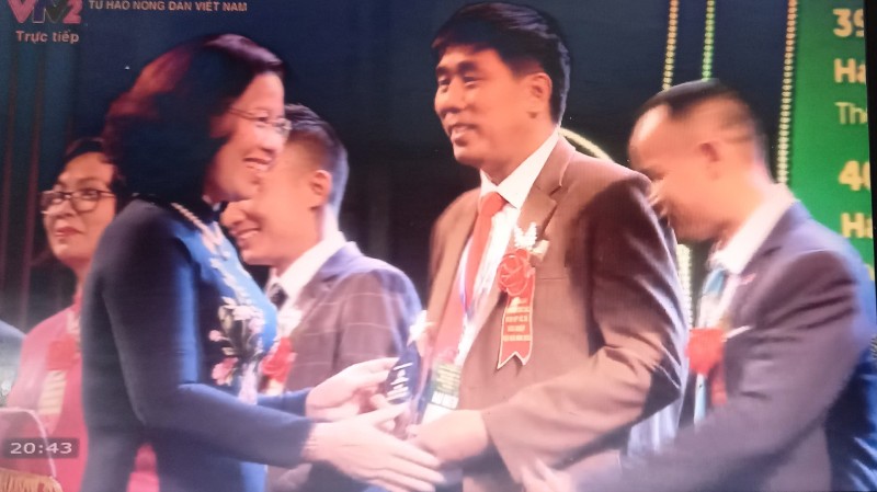 Đồng chí Bùi Thị Thơm - Phó Chủ tịch BCH Trung ương HND Việt Nam trao danh hiệu cho ông Nguyễn Văn Minh (ảnh chụp từ VTV)